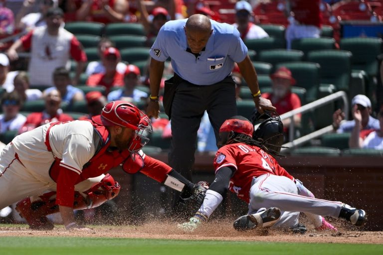 Cards rally late, upend Reds in 11 for 5th straight win