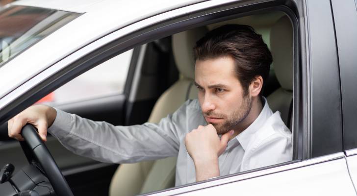 I’m 26 and recently came into $50K. I’ve got a $27K car loan — should I pay that off or invest all the money?